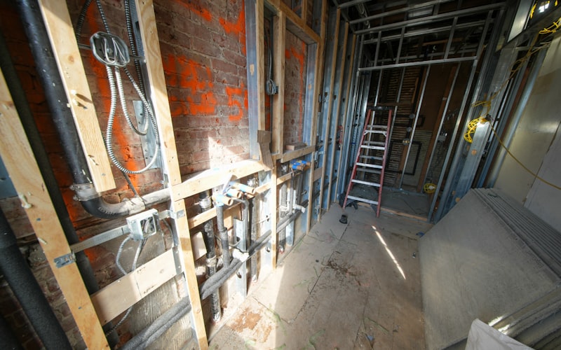 Interior construction showing exposed residential plumbing pipes